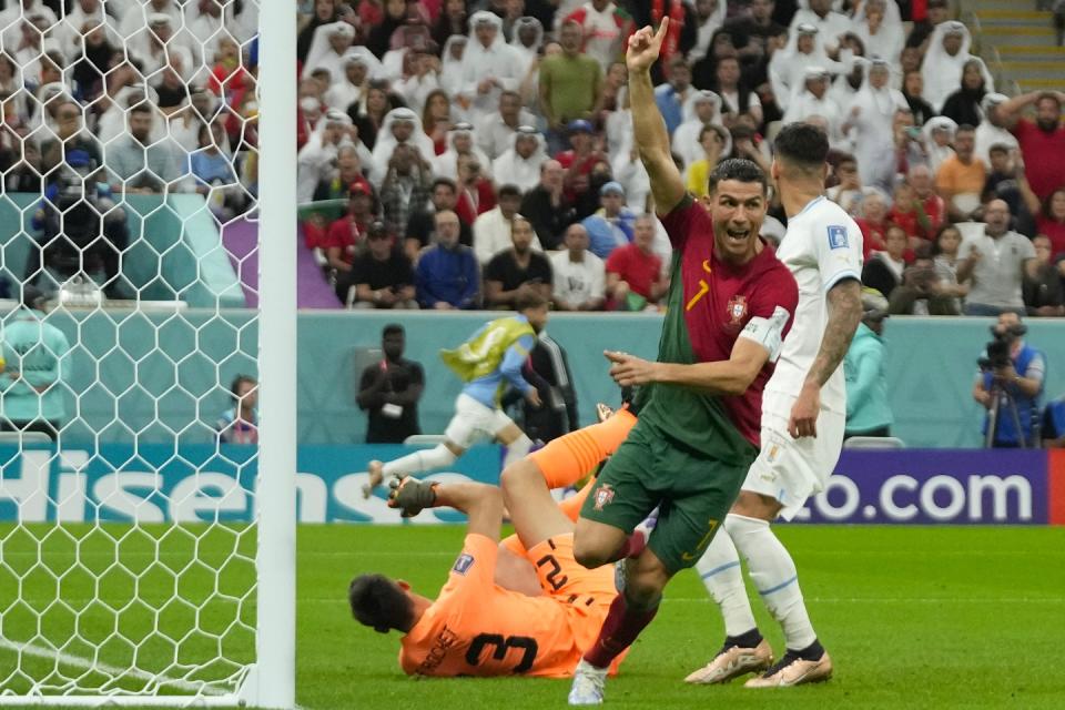 Portugal's Cristiano Ronaldo celebrates after scoring his side's opening goal during the World Cup group H football match between Portugal and Uruguay, at the Lusail Stadium in Lusail, Qatar, Monday, Nov. 28, 2022. (AP Photo/Themba Hadebe)