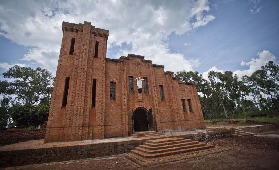 This photo taken Thursday, March 27, 2014, shows the church in the village of Nyarubuye, eastern Rwanda which was the scene of a massacre during the 1994 genocide and is now a genocide memorial. Rwandans gathered in the nearby town of Kirehe Thursday to watch the arrival of a small flame, symbolic fire traveling the country as Rwanda prepares to mark 20 years since ethnic Hutu extremists killed neighbors, friends and family during a three-month rampage of violence aimed at ethnic Tutsis and some moderate Hutus, the death toll of which Rwanda puts at 1,000,050. (AP Photo/Ben Curtis)