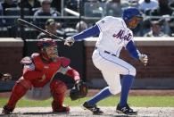 New York Mets pinch-hitter Curtis Granderson watches his seventh-inning RBI single in the Mets' 4-1 victory over the St. Louis Cardinals in a baseball game in New York, Thursday, April 24, 2014. (AP Photo/Kathy Willens)