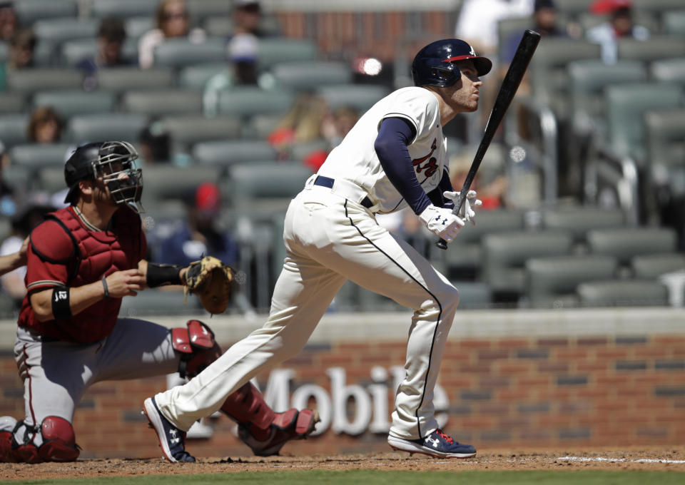 Atlanta Braves' Freddie Freeman swings for a single against the Arizona Diamondbacks in the sixth inning of the first baseball game of a double header, on Sunday, April 25, 2021, in Atlanta. (AP Photo/Ben Margot)
