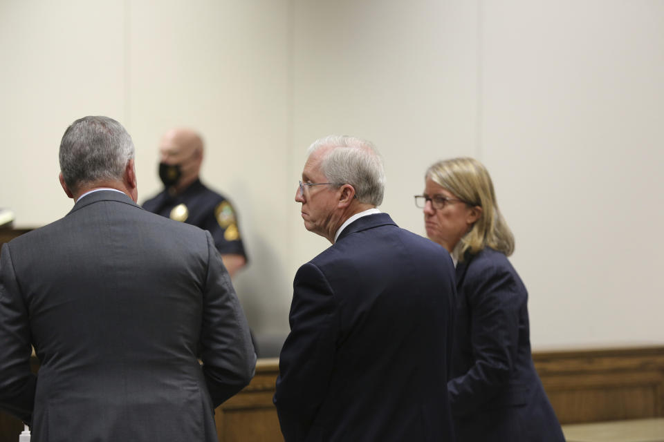 Former SCANA CEO Kevin Marsh, with his attorneys on either side, waits for a South Carolina judge to accept a plea deal that included a two-year federal prison term on Monday, Oct. 11, 2021, in Spartanburg, S.C. Marsh is the first executive to go to prison for the failed project to build two nuclear reactors which cost ratepayers billions of dollars and never generated a watt of power. (AP Photo/Jeffrey Collins)