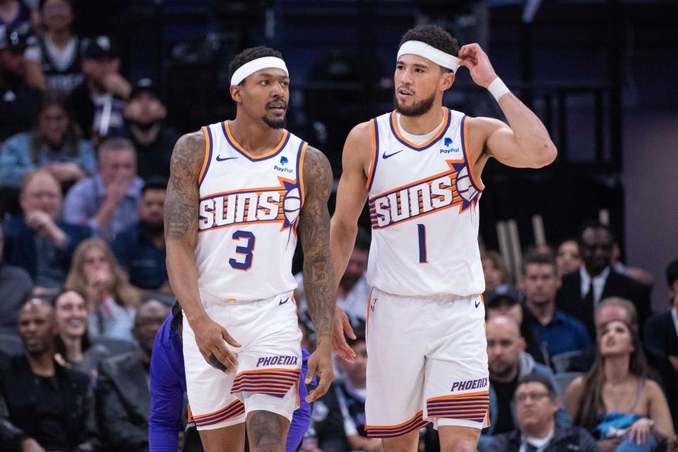 Phoenix Suns guards Bradley Beal (3) and Devin Booker (1) leave the court during a timeout in the second quarter against the Sacramento Kings at the Golden 1 Center in Sacramento on April 12, 2024.