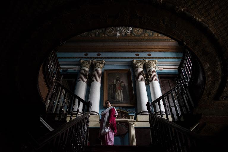 Chief librarian Janaki Karmacharya, 58, goes up the stairs of the Kaiser Library in Kathmandu on May 7, 2015