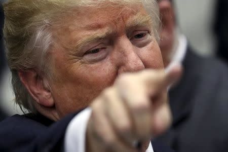 Donald Trump points to a supporter as he leaves a campaign event in an airplane hanger in Rome. REUTERS/Carlo Allegri