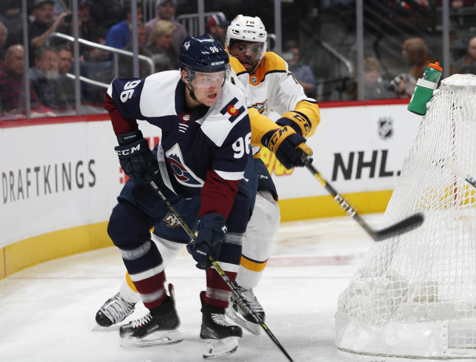 Colorado Avalanche right wing Mikko Rantanen, front, tries to maneuver around the net with the puck as Nashville Predators defenseman P.K. Subban covers in the first period of an NHL hockey game Monday, Jan. 21, 2019, in Denver. (AP Photo/David Zalubowski)