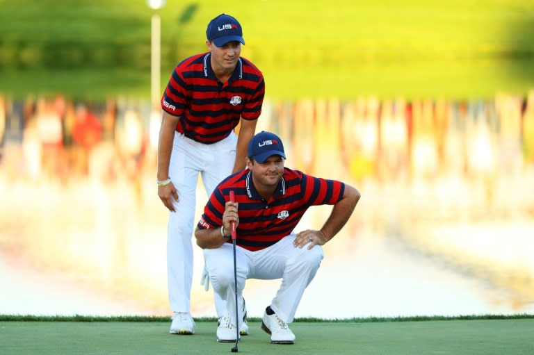 Jordan Spieth and Patrick Reed of the Team USA line up a putt on the 17th green during afternoon fourball matches of the 2016 Ryder Cup, at Hazeltine National Golf Club in Chaska, Minnesota, on October 1