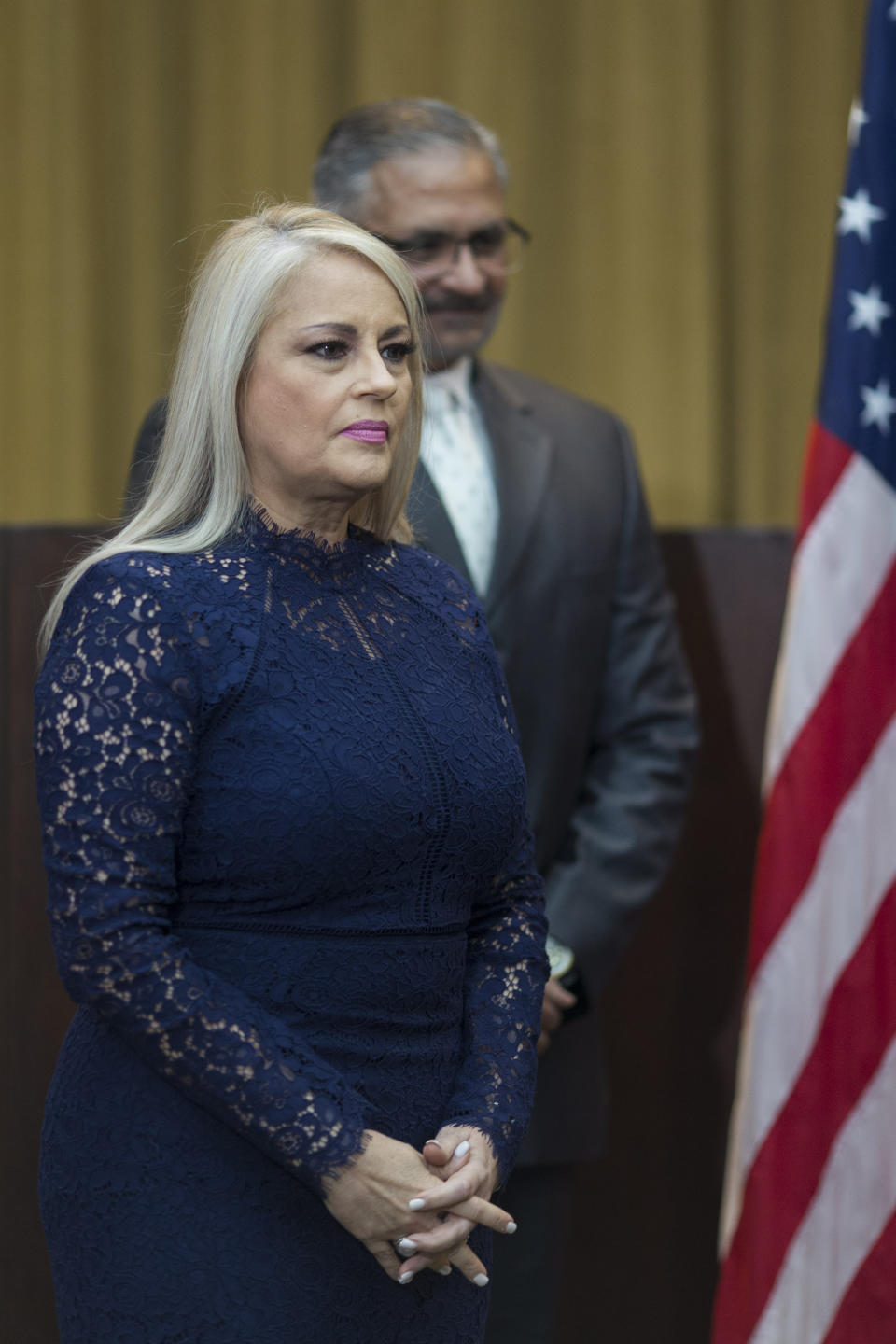 Justice Secretary Wanda Vazquez is accompanied by her husband Judge Jorge Diaz during her swearing in ceremony as Puerto Rico's new governor, in San Juan, Puerto Rico, Wednesday, Aug. 7, 2019. Vazquez took the oath of office early Wednesday evening at the Puerto Rican Supreme Court, which earlier in the day ruled that Pedro Pierluisi's swearing in last week was unconstitutional. (AP Photo/Dennis M. Rivera Pichardo)