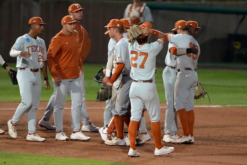 Texas players console each other after a 7-6 loss to Stanford.