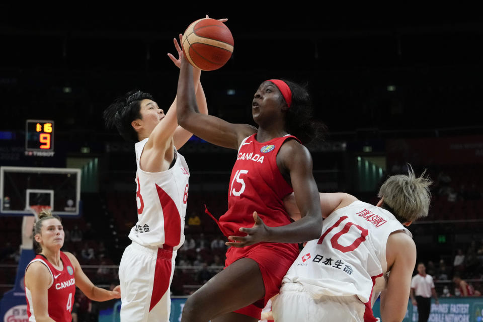 Canada's Laeticia Amihere, centre, competes for the ball with Japan's Himawari Akaho, left, and Ramu Tokashiki during their game at the women's Basketball World Cup in Sydney, Australia, Sunday, Sept. 25, 2022. (AP Photo/Mark Baker)