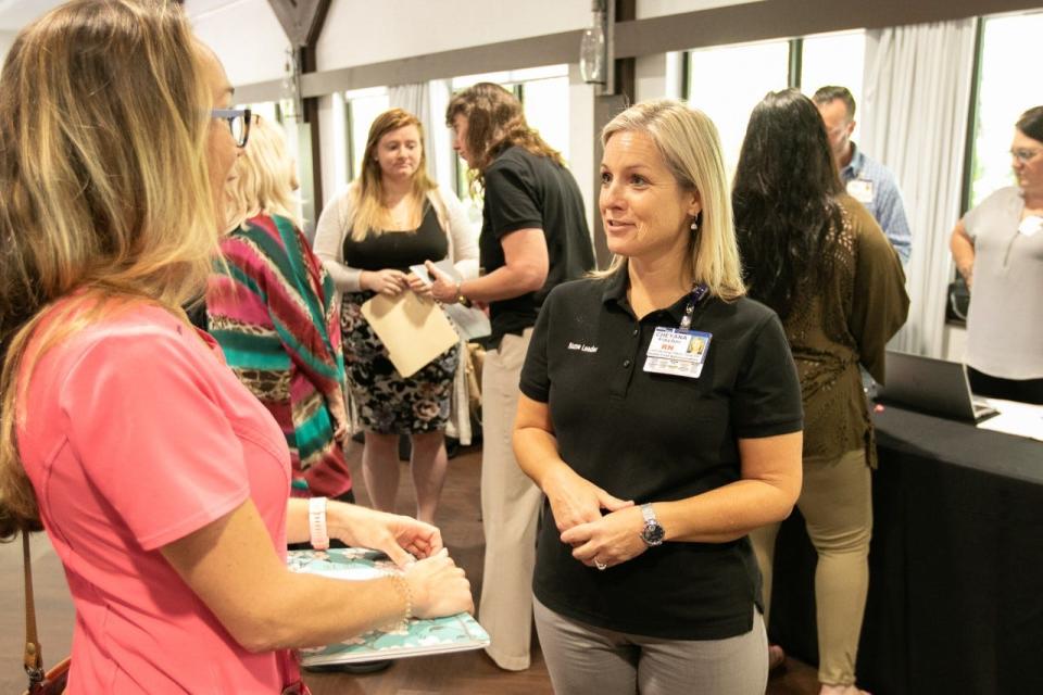 Cheyana Fischer, at right, chief nursing officer and chief operating officer at Health First, talks with an attendee at Health First's recent job fair at the Brevard Zoo.