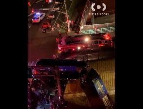 Section of bus is seen hanging from Cross Bronx Expressway overpass in New York City on night of January 14, 2021. / Credit: The Citizen App