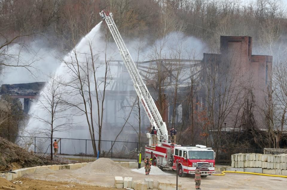 Akron firefighters on the scene of a fire at the former Ace Rubber factory on Beech Street Thursday, the day after the fire started. The fire consumed the entire three-story building.