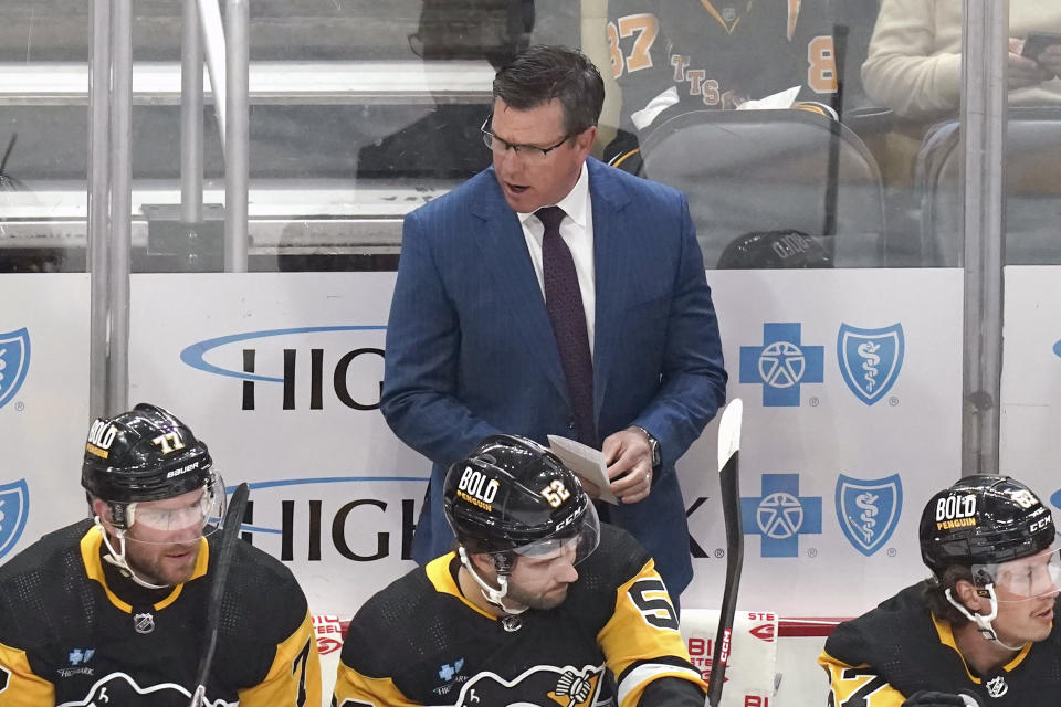 Pittsburgh Penguins head coach Mike Sullivan, center top, calls instructions to his players during the first period of an NHL hockey game against the Nashville Predators, Monday, April 15, 2024, in Pittsburgh. (AP Photo/Matt Freed)
