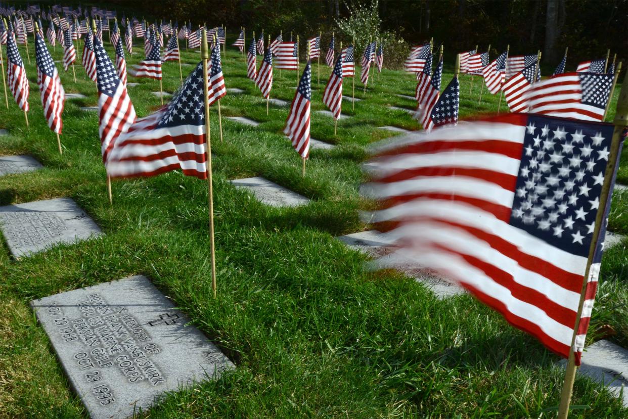 A westerly wind opens the flags at the Bourne National Cemetery on Saturday where hundreds of volunteers turned out to place thousands of flags on all the graves as part of Operation Flags for Vets in observance of next Saturday's Veteran's Day.