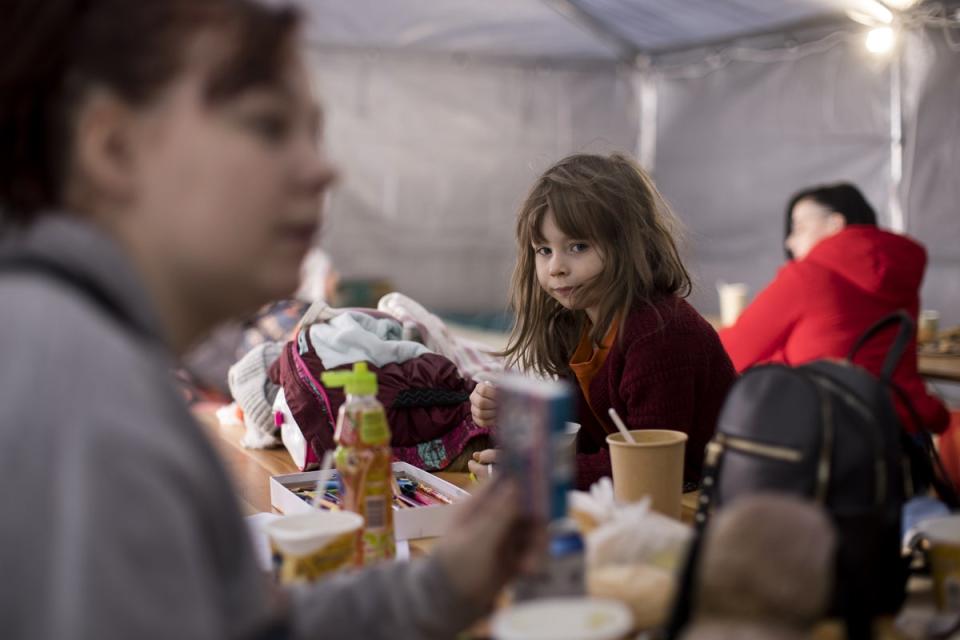 Lilia, six, with her mother Mila at the Caritas tent on the Ukraine/Poland border at Kroscienko (Toby Madden/DEC/PA) (PA Media)