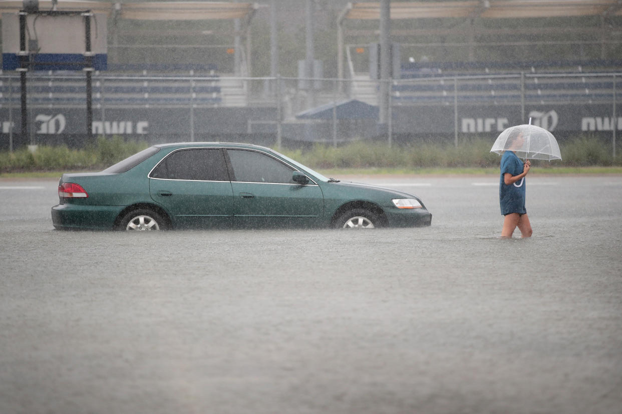 A woman walks through a flooded parking lot at Rice University in Houston last week.&nbsp;