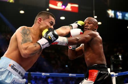 May 3, 2014; Las Vegas, NV, USA; Floyd Mayweather Jr. (right) is punched by Marcos Maidana during their fight at MGM Grand. Mandatory Credit: Mark J. Rebilas-USA TODAY Sports