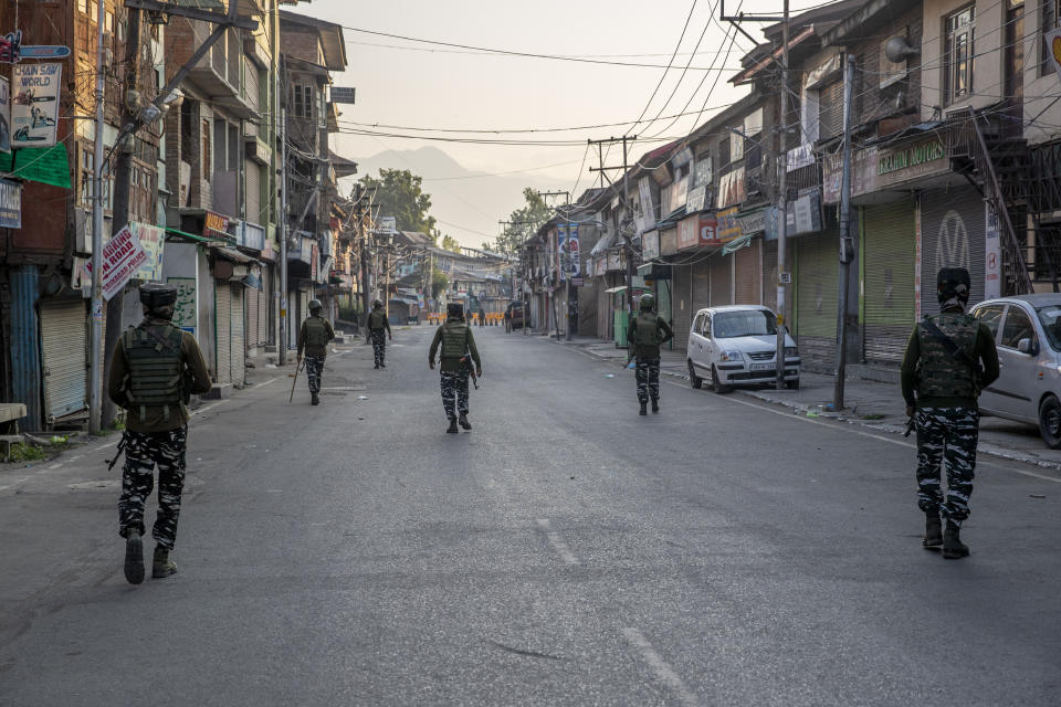 Indian paramilitary soldiers patrol a deserted street on the first anniversary of India’s decision to revoke the disputed region’s semi-autonomy, in Srinagar, Indian controlled Kashmir, Wednesday, Aug. 5, 2020. Last year on Aug. 5, India’s Hindu-nationalist-led government of Prime Minister Narendra Modi stripped Jammu-Kashmir of its statehood and divided it into two federally governed territories. Late Tuesday, authorities lifted a curfew in Srinagar but said restrictions on public movement, transport and commercial activities would continue because of the coronavirus pandemic. (AP Photo/ Dar Yasin)