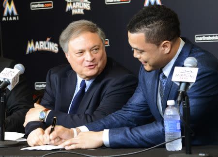 Marlins owner Jeffrey Loria (L) and Giancarlo Stanton, speak to the media at the Marlins Ballpark in Little Havana, Miami, Florida, November 19, 2014. REUTERS/Zachary Fagenson