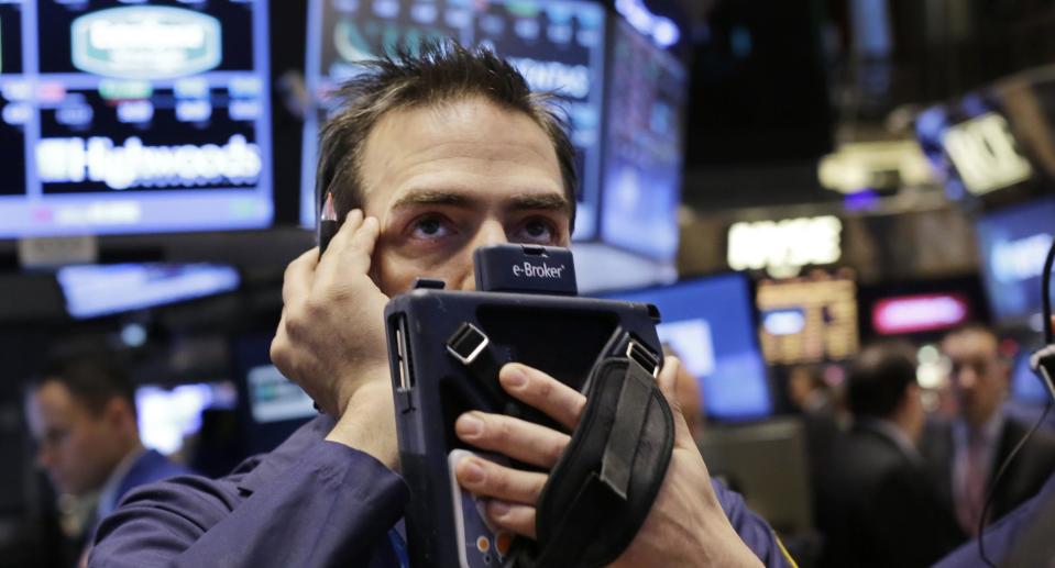 Stock trader Gregory Rowe works at the New York Stock Exchange, Thursday, Jan. 2, 2014, in New York. Stocks are opening lower on Wall Street as the market comes off of its biggest annual gain in nearly two decades. (AP Photo/Mark Lennihan)