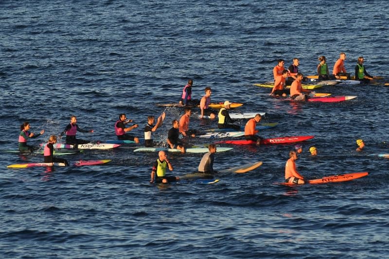 Members of the Bondi Board Riders Club and various local sports clubs and lifeguards take part in a "paddle out" on surfboards at Bondi Beach to honor and remember the victims of the knife attack at Westfield Bondi Junction shopping mall. Steven Saphore/AAP/dpa