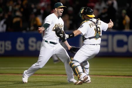 May 7, 2019; Oakland, CA, USA; Oakland Athletics starting pitcher Mike Fiers (50) celebrates with catcher Josh Phegley (19) after pitching a no hitter against the Cincinnati Reds at Oakland Coliseum. Mandatory Credit: Stan Szeto-USA TODAY Sports