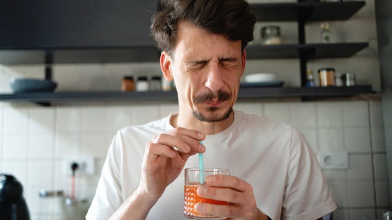 Man tasting a bitter drink