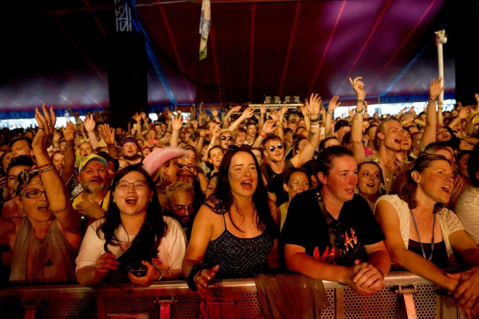The crowd watch Glastonbury founder Michael Eavis performing with his band (PA)
