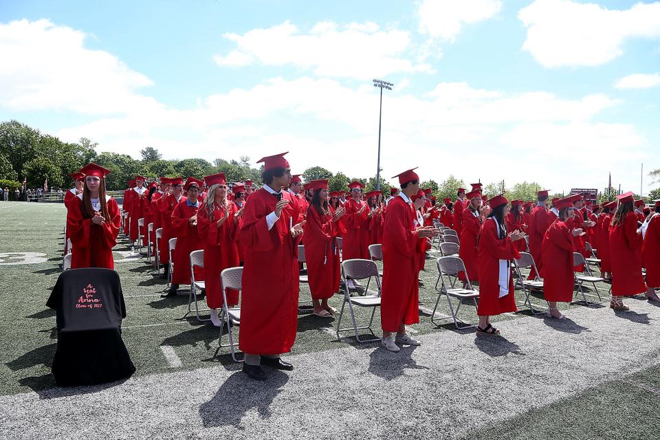 Members of the Hingham High Class of 2022 give a standing ovation for classmate Anna Quinlivan, who receives her diploma posthumously during Hingham High's graduation Saturday, June 4, 2022.