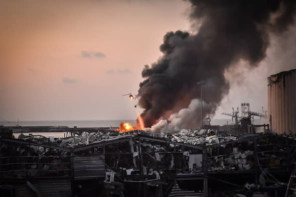 A military helicopter tries to put out a fire at the port after the explosion in Beirut, Lebanon. 