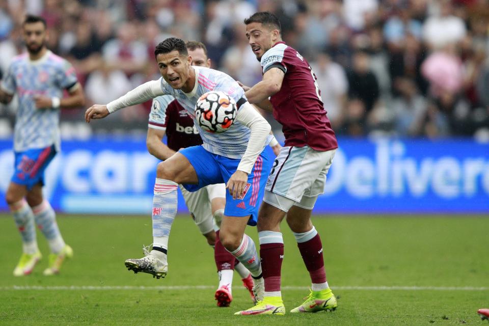 Manchester United's Cristiano Ronaldo, left, goes for the ball as West Ham's Pablo Fornals tries to stop him during the English Premier League soccer match between West Ham United and Manchester United at the London Stadium in London, England, Sunday, Sept. 19, 2021. (AP Photo/Ian Walton)