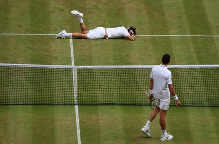 Britain Tennis - Wimbledon - All England Lawn Tennis & Croquet Club, Wimbledon, England - 8/7/16 Canada's Milos Raonic looks on after Switzerland's Roger Federer fell during their match REUTERS/Adam Davy/Pool