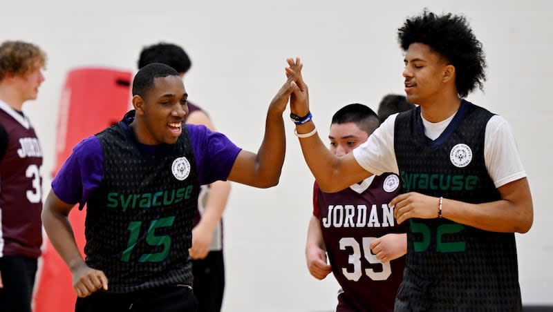 Two Syracuse players celebrate after a basket as hundreds of special needs youth participate in the Unified Basketball Tournament at the University of Utah in Salt Lake City on Friday, March 8, 2024.