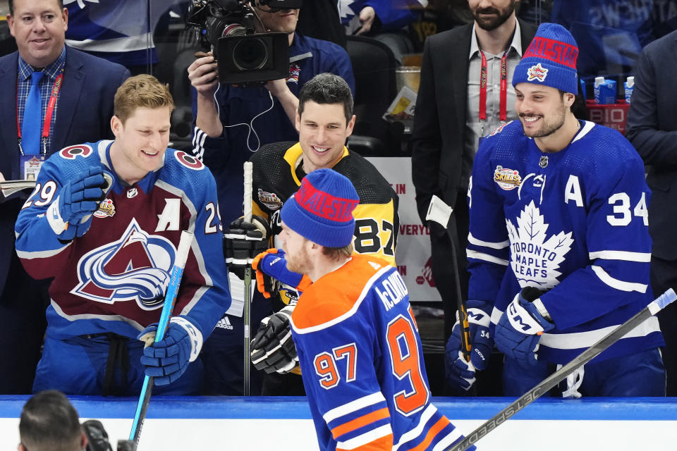 Edmonton Oilers' Connor McDavid is congratulated by Colorado Avalanche's Nathan MacKinnon, left to right, Pittsburgh Penguins' Sidney Crosby and Toronto Maple Leafs' Auston Matthews after winning the NHL All-Star hockey skills competition in Toronto, Friday, Feb. 2, 2024. (Frank Gunn/The Canadian Press via AP)