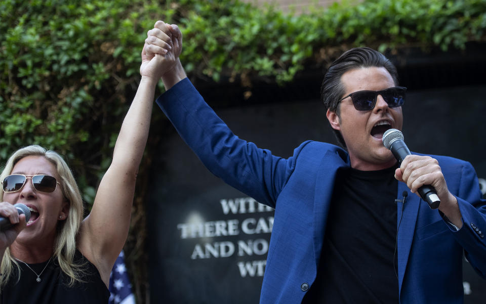 Republican Reps. Marjorie Taylor Greene and Matt Gaetz make an appearance at a rally Saturday, July 17, 2021, in Riverside, Calif. The two held a protest after a third venue in California canceled their event. Instead, they held a protest outside City Hall in Riverside, where one of the events was canceled. An Anaheim spokesman had announced the latest cancellation hours before the rally was scheduled to begin. (Cindy Yamanaka/The Orange County Register via AP)