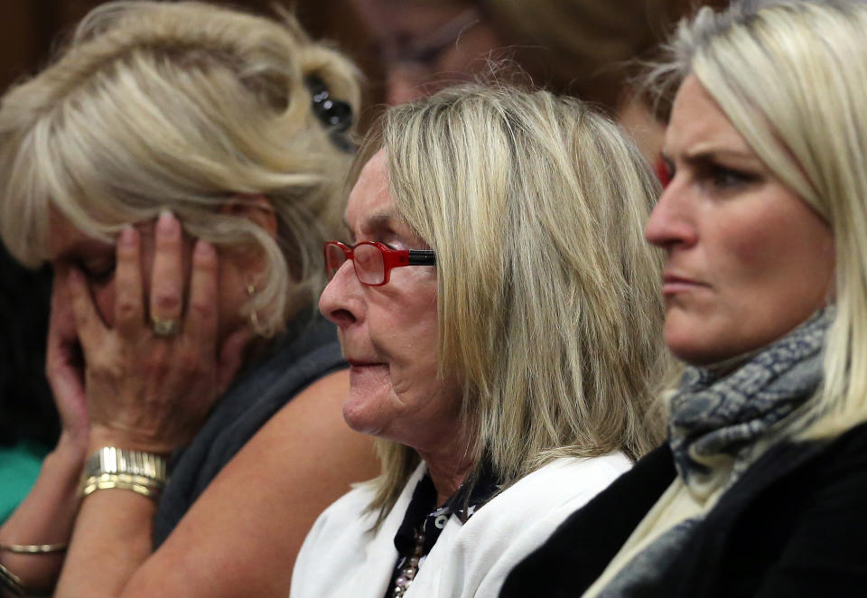 June Steenkamp, center, mother of the late Reeva Steenkamp, listens in the public gallery, as state prosecutor Gerrie Nel questions Oscar Pistorius, in court in Pretoria, South Africa, Friday, April 11, 2014. Pistorius is charged with the murder of his girlfriend Steenkamp, on Valentines Day in 2013. (AP Photo/Themba Hadebe, Pool)