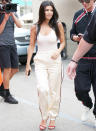 <p>Kourtney looked sporty as she stepped out to celebrate Cinco de Mayo at landmark Casa Vega restaurant in Studio City, Calif., wearing a revealing white leotard ($73; <a rel="nofollow noopener" href="http://www.houseofcb.com/luca-white-seamless-knit-stretch-bodysuit-en.html" target="_blank" data-ylk="slk:houseofcb.com;elm:context_link;itc:0;sec:content-canvas" class="link ">houseofcb.com</a>) with white track pants and killer red stiletto sandals. She confidently rocked the braless look (we all know Kardashians love a bodysuit) and kicked the sportif style up a notch with the addition of <i>those heels</i>. </p>