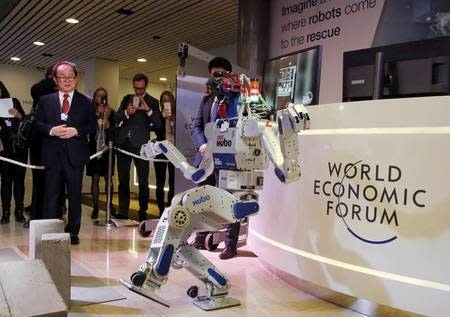 HUBO, a multifunctional walking humanoid robot performs a demonstration of its capacities next to its developer Oh Jun-Ho, Professor at the Korea Advanced Institute of Science and Technology (KAIST) during the annual meeting of the World Economic Forum (WEF) in Davos, Switzerland January 20, 2016. REUTERS/Ruben Sprich