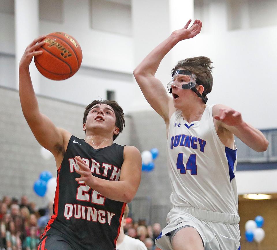 Quincy's Charlie Coffey tries to block a layup attempt by North Quincy's Nate Caldwell.
Quincy High hosted North Quincy High in basketball. Both girls and boys teams played on Friday January 20, 2023.