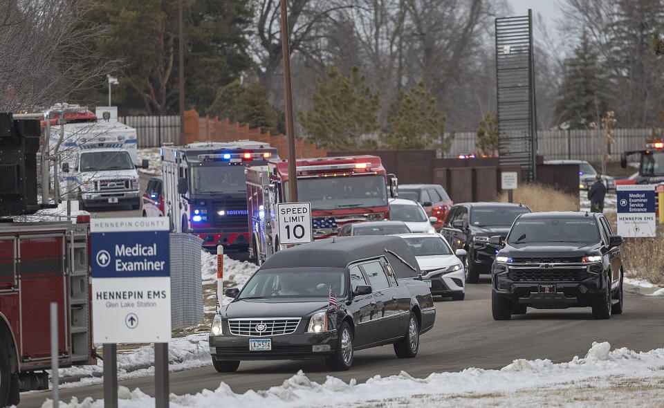 The hearse bearing the body of Burnsville firefighter and paramedic Adam Finseth leaves the Hennepin County Medical Examiner in Minnetonka, Minn., Monday, Feb. 19, 2024. Finseth and two police officers were shot and killed early Sunday and a third officer was injured at a suburban Minneapolis home in an exchange of gunfire while responding to a call involving an armed man who had barricaded himself inside with family. (Elizabeth Flores/Star Tribune via AP)