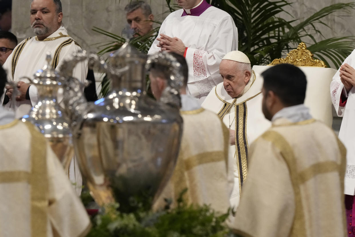 Pope Francis blesses chrism oil contained in a jar during a Chrism Mass where the chrism, the oil of the catechumens and the oil of the sick are consecrated, and all the priests renew the promises made on the day of their ordination, inside St. Peter's Basilica, at the Vatican, Thursday, April 6, 2023. (AP Photo/Andrew Medichini)