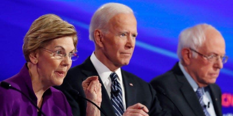 FILE PHOTO: Democratic 2020 U.S. presidential candidates Senator Elizabeth Warren (D-MA) speaks with former Vice President Joe Biden and Senator Bernie Sanders (I-VT) listening at the seventh Democratic 2020 presidential debate at Drake University in Des Moines, Iowa, U.S., January 14, 2020. REUTERS/Shannon Stapleton/File Photo