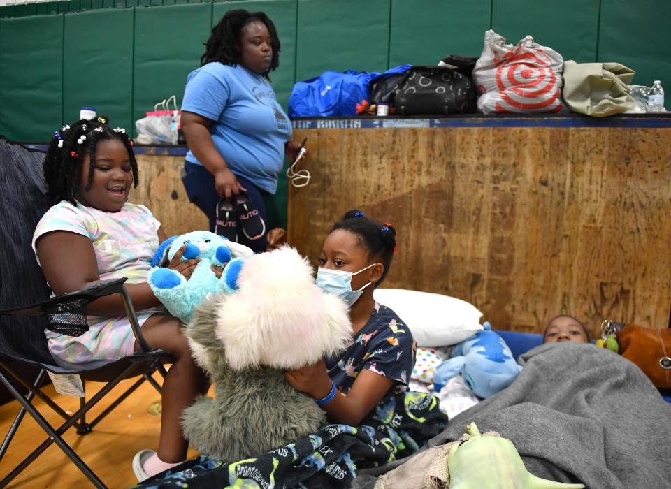 Ronisha  Taylor, of North Port, with her family, from left, Ramiyah, 5, Passiion, 11, and Victor, Jr., 13 in the old gymnasium at Venice High, which is being used as a hurricane shelter on Monday, Oct. 3, 2022 following Hurricane Ian. "You gotta stay positive because of the kids. They feed off of that." she said. 