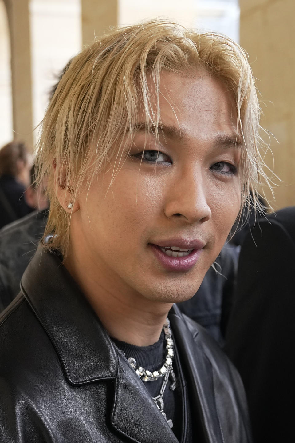 South Korean singer Taeyang, left, arrives for Givenchy Menswear Spring/Summer 2024 fashion collection presentation in Paris, Thursday, June 22, 2023. (AP Photo/Michel Euler)