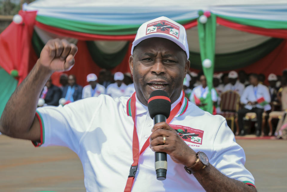 Burundi Army Gen. Evariste Ndayishimiye gestures to party supporters after being chosen as their presidential candidate, at a national conference for the ruling CNDD-FDD party in the rural province of Gitega, Burundi Sunday, Jan. 26, 2020. Burundi's ruling party chose Gen. Evariste Ndayishimiye to be its candidate in the presidential election set for May, signaling that the country's current president Pierre Nkurunziza will now retire after serving three terms. (AP Photo/Berthier Mugiraneza)