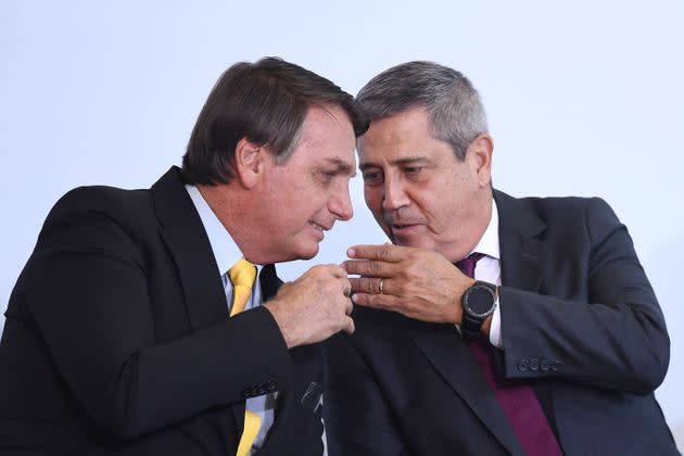 Brazilian Minister of Defense Walter Braga Netto, an Army general, told congressional leaders that there would be no elections in 2022 if changes that President Jair Bolsonaro (left) wants aren't made to the country's electronic voting system, according to a report from a major Brazilian newspaper. (Photo: EVARISTO SA via Getty Images)