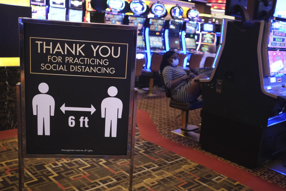 A sign asks people to practice social distancing the Golden Nugget Casino in Atlantic City, N.J., Thursday, July 2, 2020. Eager to hit the slot machines and table games after a 108-day absence, gamblers wore face masks and did without smoking and drinking Thursday as Atlantic City's casinos reopened amid the coronavirus pandemic that has drastically changed things both inside and outside the casino walls. (AP Photo/Seth Wenig)