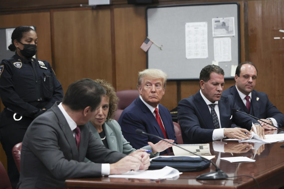 Donald Trump sits in the courtroom with his attorneys Todd Blanche, Susan Necheles, Joe Tacopina, and Boris Epshteyn during his arraignment.