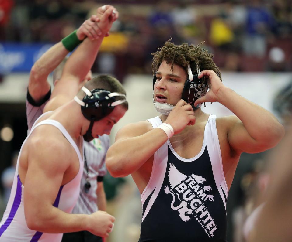 Buchtel's Davian Greenlee takes off his headgear as Columbus St. Francis DeSales' Max Shulaw is declared the winner of their Division II 215 pound preliminary match on day one of the OHSAA State Wrestling Tournament at the Jerome Schottenstein Center on Friday.