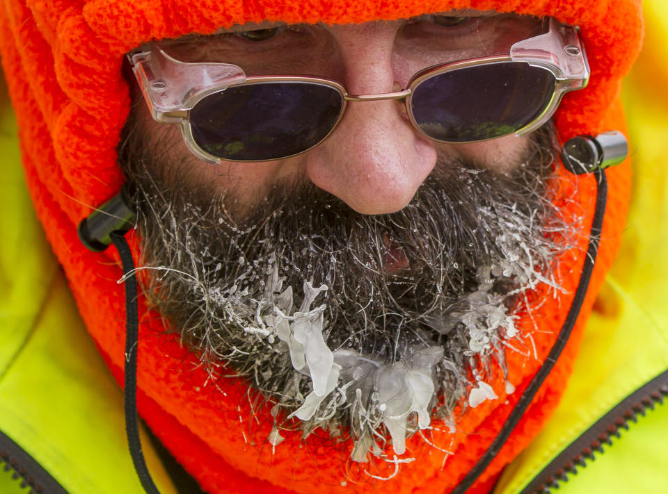 Ice forms on the beard of Bob Schweitzer as he helps clear ice and snow from the seats at Lambeau Field on Friday, Jan. 3, 2014, in Green Bay, Wis., in preparation for Sunday's NFl football wild-card playoff game between the Green Bay Packers and San Francisco 49ers. (AP Photo/Mike Roemer)